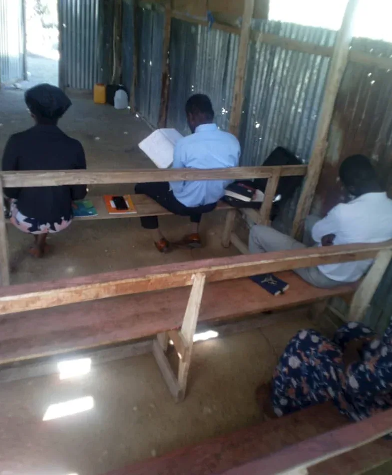 Simple wooden benches in a tin-walled church in rural Haiti